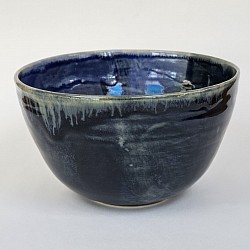 Handmade mixed blue and shino pottery bowl.