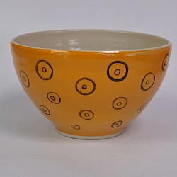 Yellow orange handmade bowl with black circles