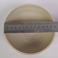 Orange yellow bowl with black circles top view with width in cm