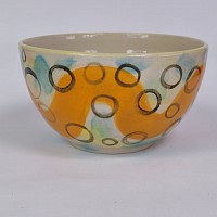 Multicoloured bowl with wavy orange line and black circles
